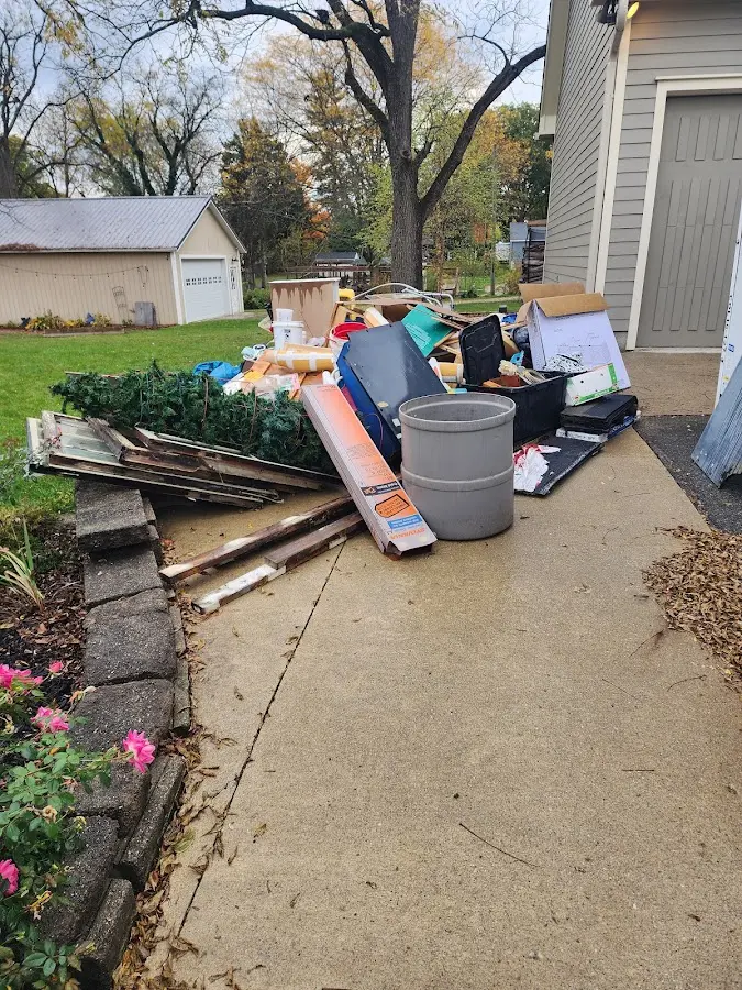 Dumpster being loaded with debris for Estate Cleanout Dumpster Rental in Clarendon